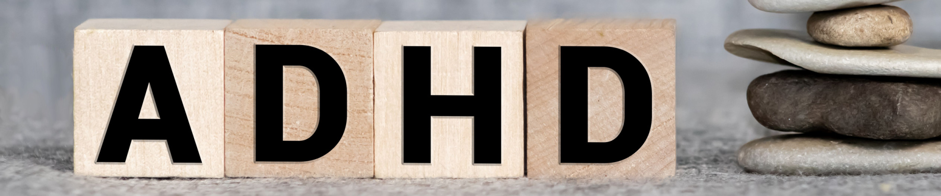 ADHD abbreviation on wooden blocks. ADHD is Attention deficit hyperactivity disorder. Close up. Vignette.