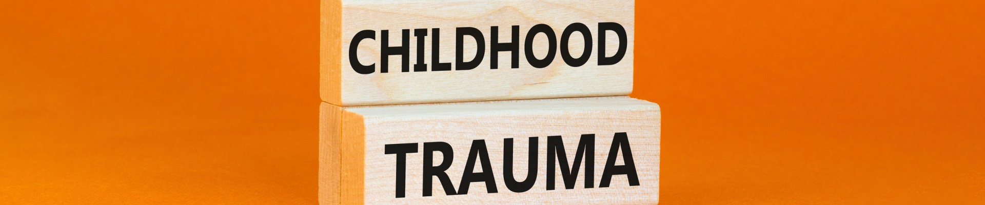 Childhood trauma symbol. Concept words Childhood trauma on beautiful wooden blocks. Beautiful orange table orange background. Business psychology childhood trauma concept. Copy space.