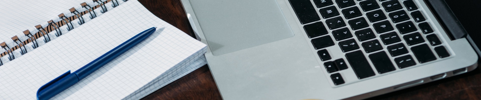 close up of laptop with empty notebooks and apple